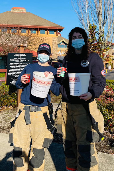 Volunteers posing with fundraiser buckets 